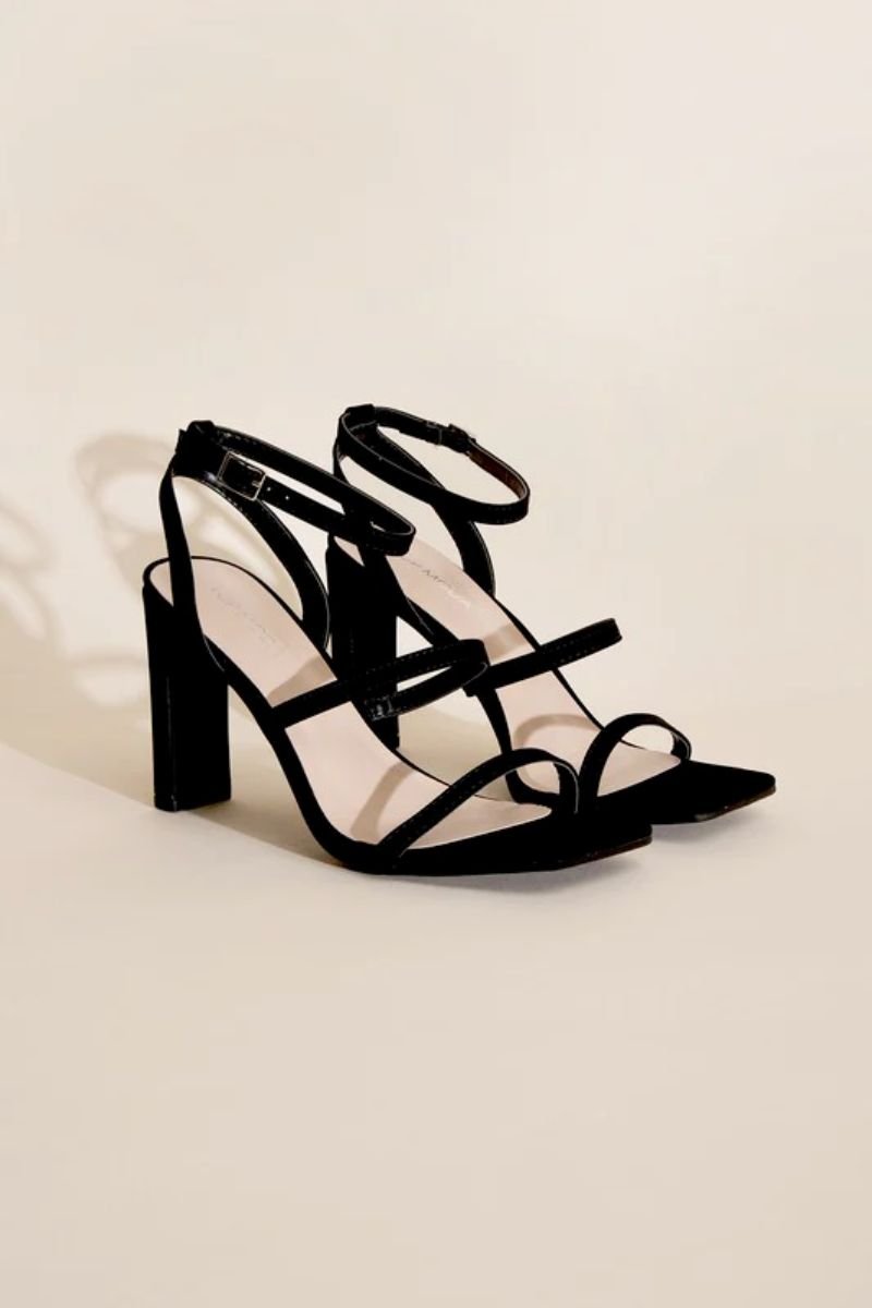 Ankle Strap Heels. There is a black pair of heels with silver buckles.