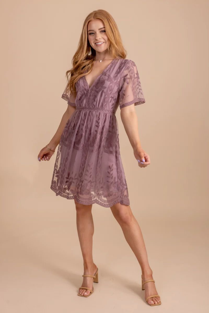 Light My Fire Mauve Lace Mini Dress. The model has red hair and is wearing a mauve dress with a deep v neckline and lace sleeves.