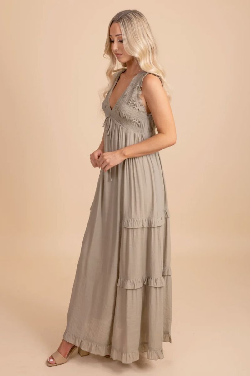 Now Until Forever V-Neck Maxi Dress. The model is wearing a long light green dress with no sleeves and a deep v neck.