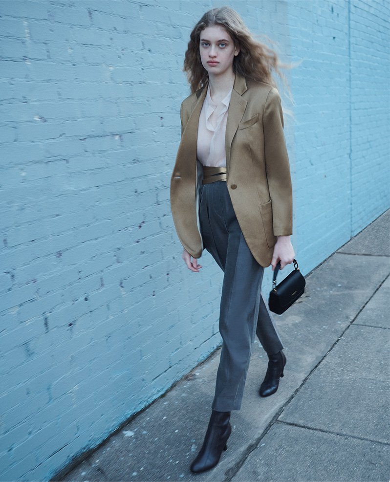 Model wears Single-breasted jacket in ottoman silk and Double-pleat, silk-shantung trousers