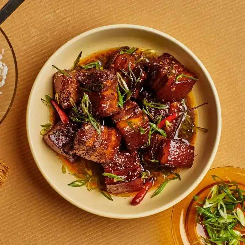 Sake-and-Soy Braised Pork Belly in a white bowl 