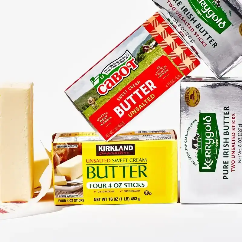 Three different types of butter leaning on each other isolated on white.