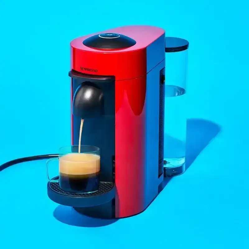 A nesspresso dispensing coffee to a cup