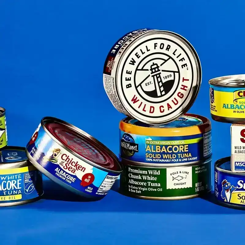 a variety of Cans of Tuna on a blue background 