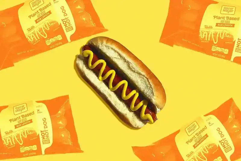 still of a vegan hot dog and hot dog packaging