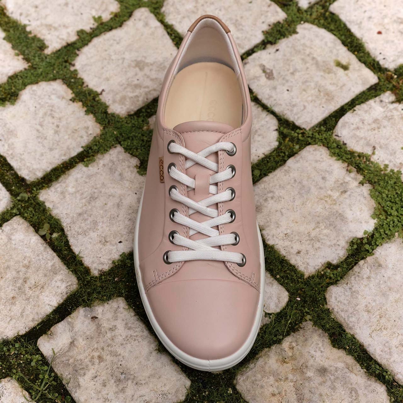 Pink SOFT 7 sneaker on stone walkway