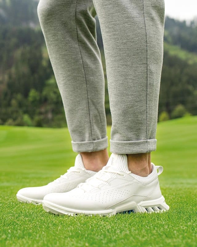 Golfer wearing white golf shoes
