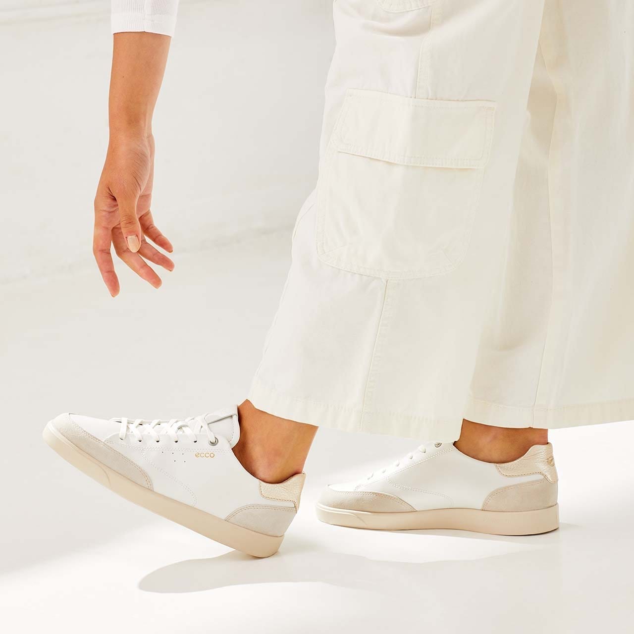 Woman wearing white sneakers