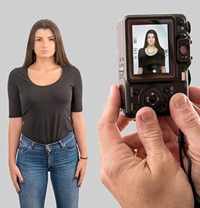 A woman poses for her passport photo.