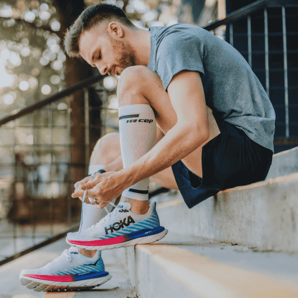 Man tying HOKA Mach 5 shoes