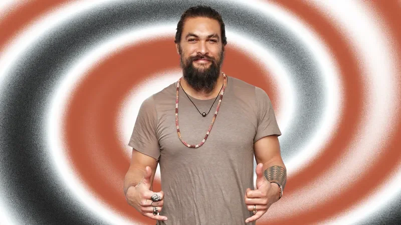Image may contain: Jason Momoa, Accessories, Jewelry, Necklace, Adult, Person, Clothing, T-Shirt, Pendant, Face, and Head