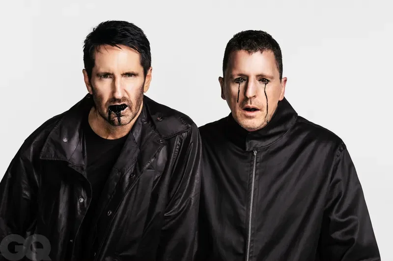Image may contain: Trent Reznor, Atticus Ross, Clothing, Coat, Jacket, Adult, Person, Head, Face, Photography, and Portrait