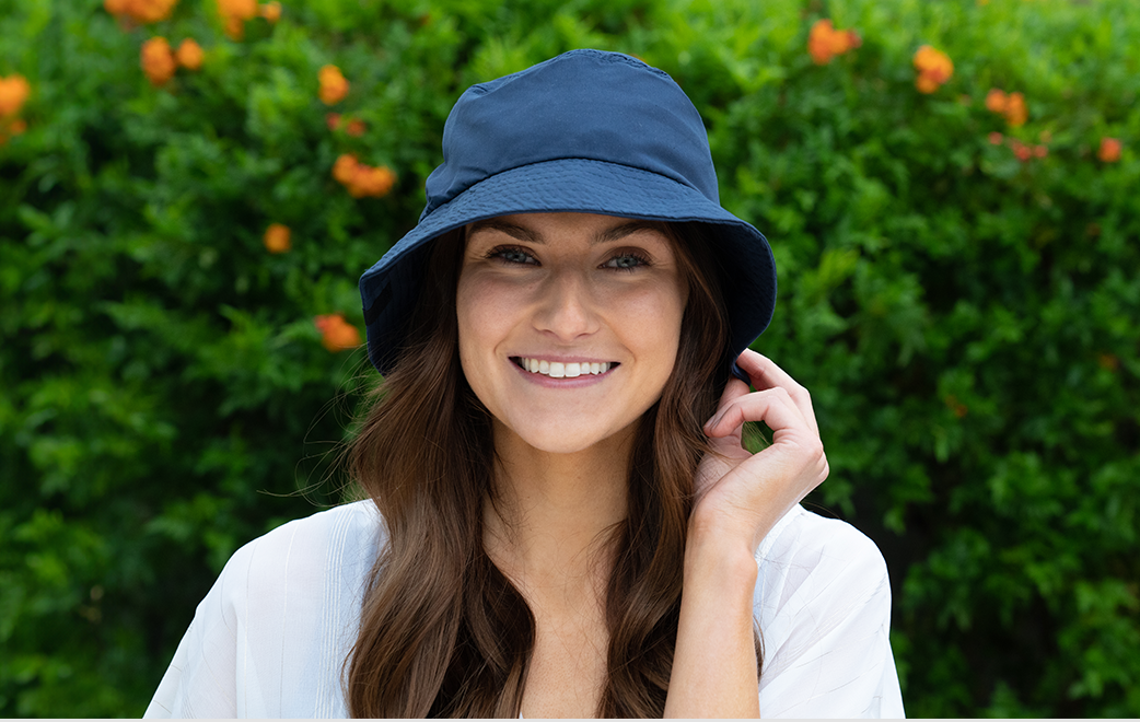 A woman Smiling and wearinf Mission Hat