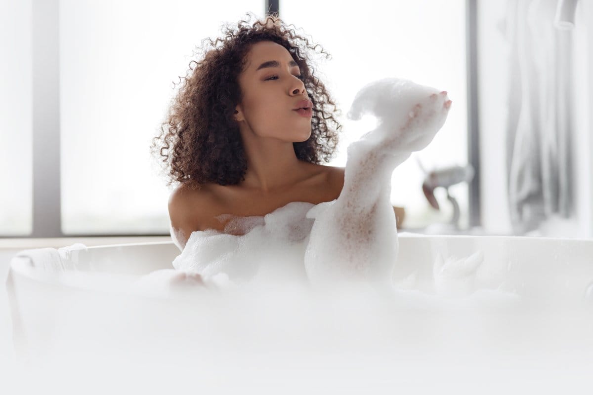 Woman taking an aromatic bubble bath