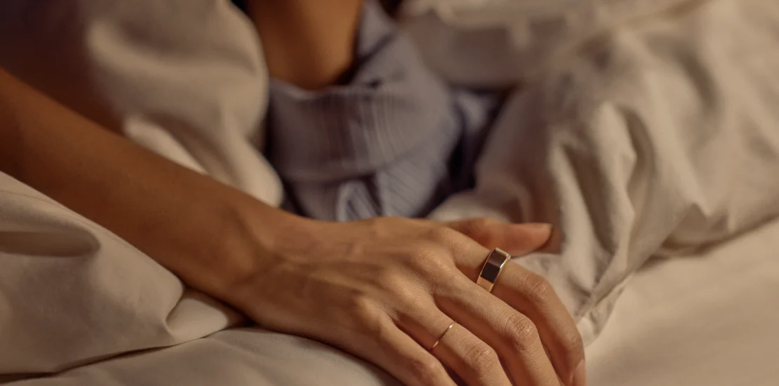 Person Laying in Bed Wearing Oura Ring