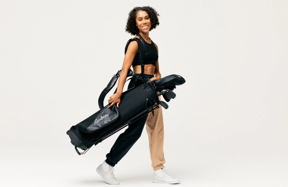 Woman holding golf set