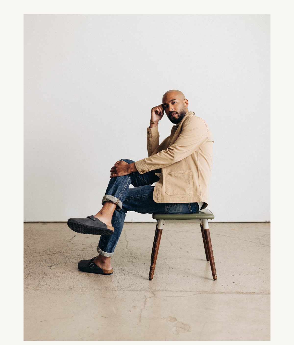 Fit model sitting wearing The Ojai Jacket in Organic Dried Earth Foundation Twill 