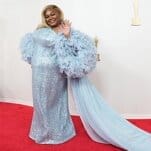 Da’Vine Joy Randolph waving on the red carpet in a glittery, pale-blue dress with poufy sleeves and a gauzy train.