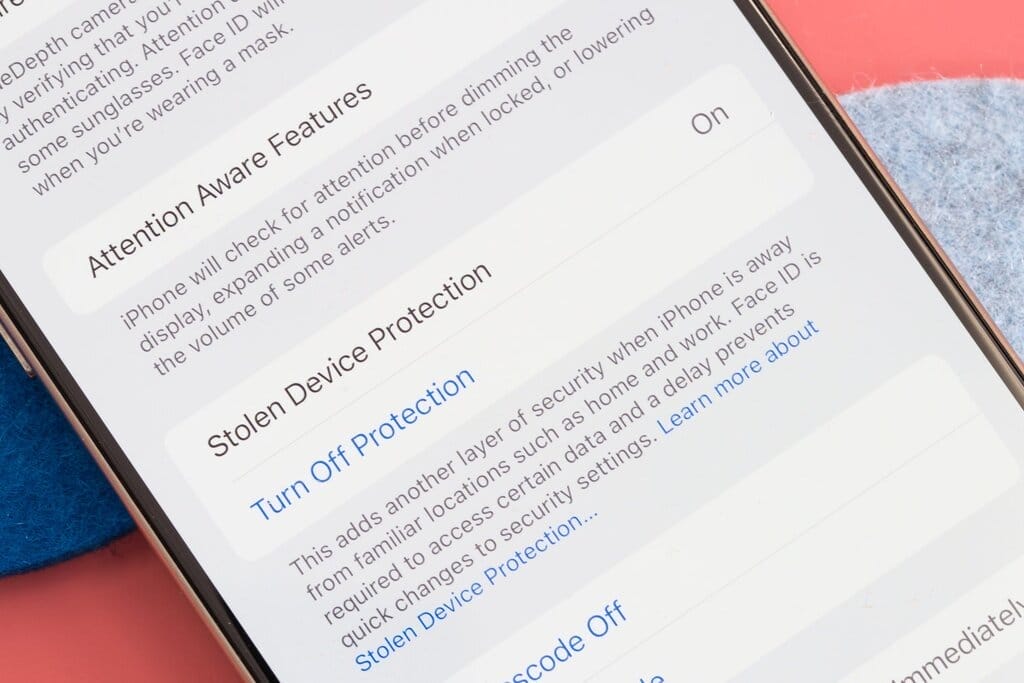 A close-up image of an iPhone screen with the text “Stolen Device Protection” on the screen next to the word “On.”